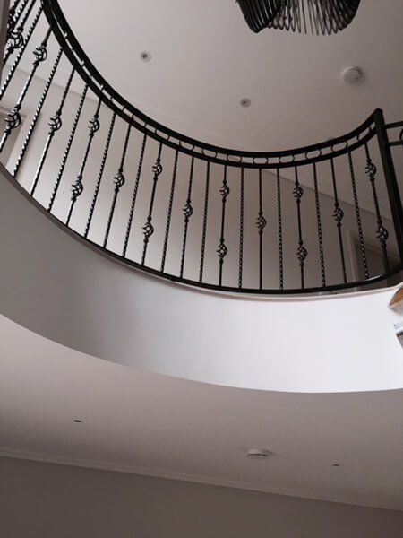 Black metal fencing inside a building