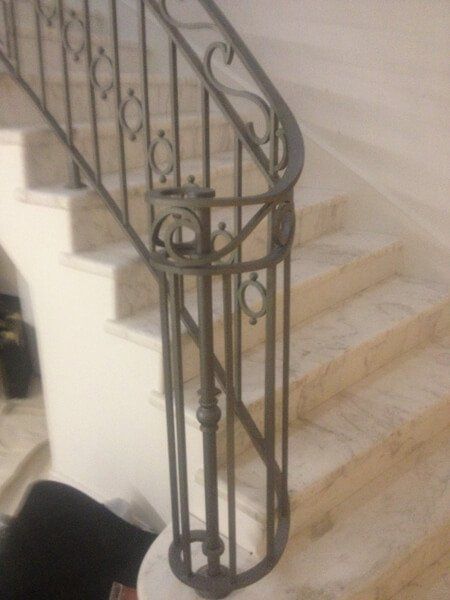 Wooden staircase with brushed metal handrail
