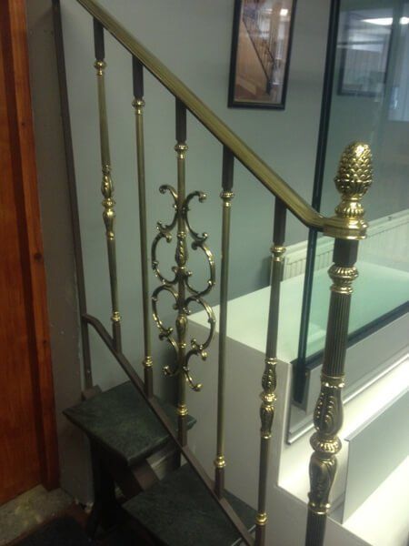 Marble staircase with glossy brass handrail