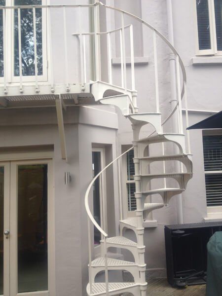Outdoor spiral staircase with white metal finish