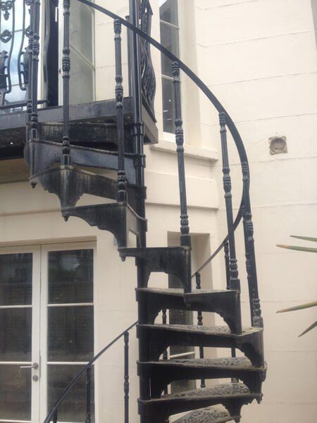 Outdoor spiral staircase in a black metal finish