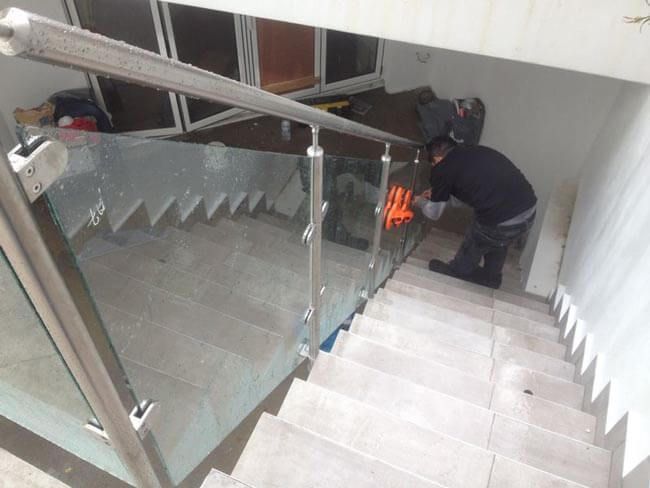 Glass staircase with silver handrail