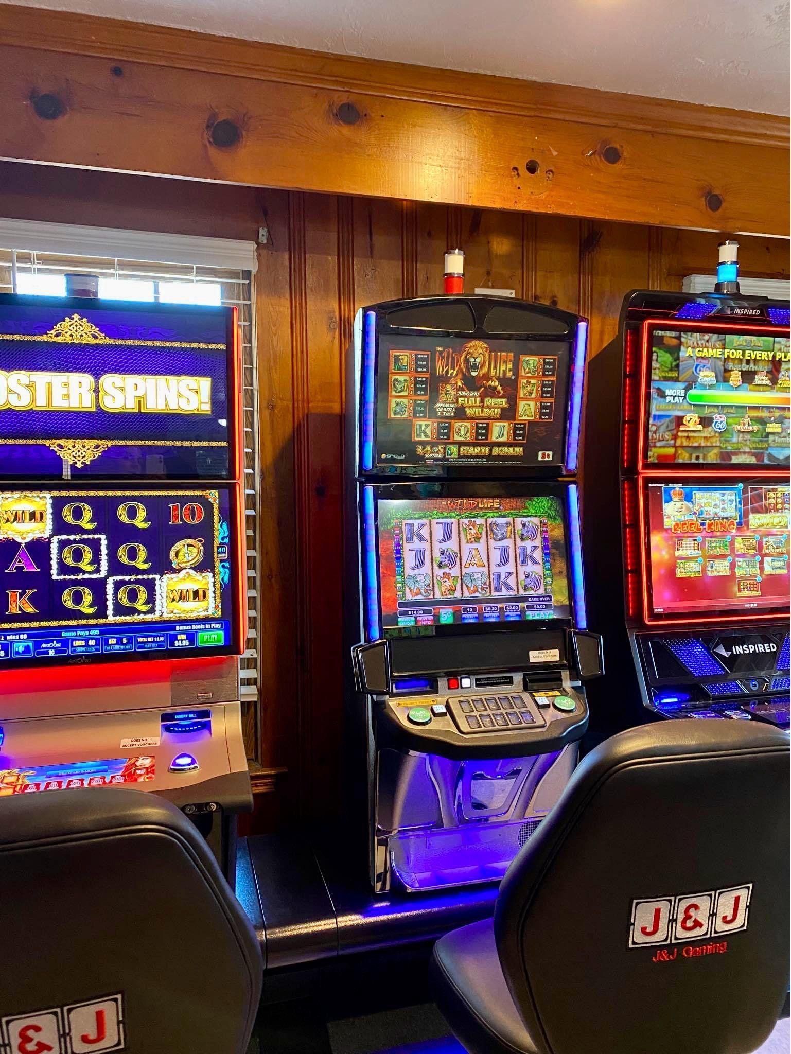 A couple of slot machines sitting next to each other in a room.
