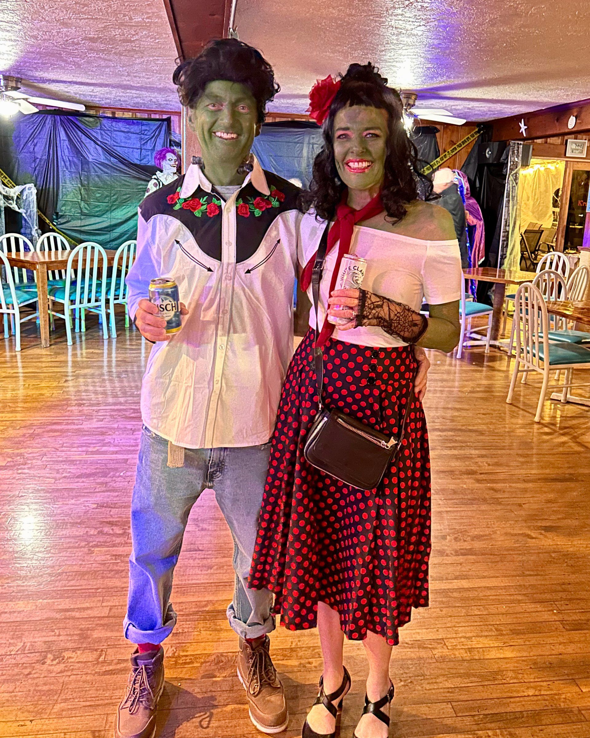 A man and a woman in costumes are standing next to each other in a room.