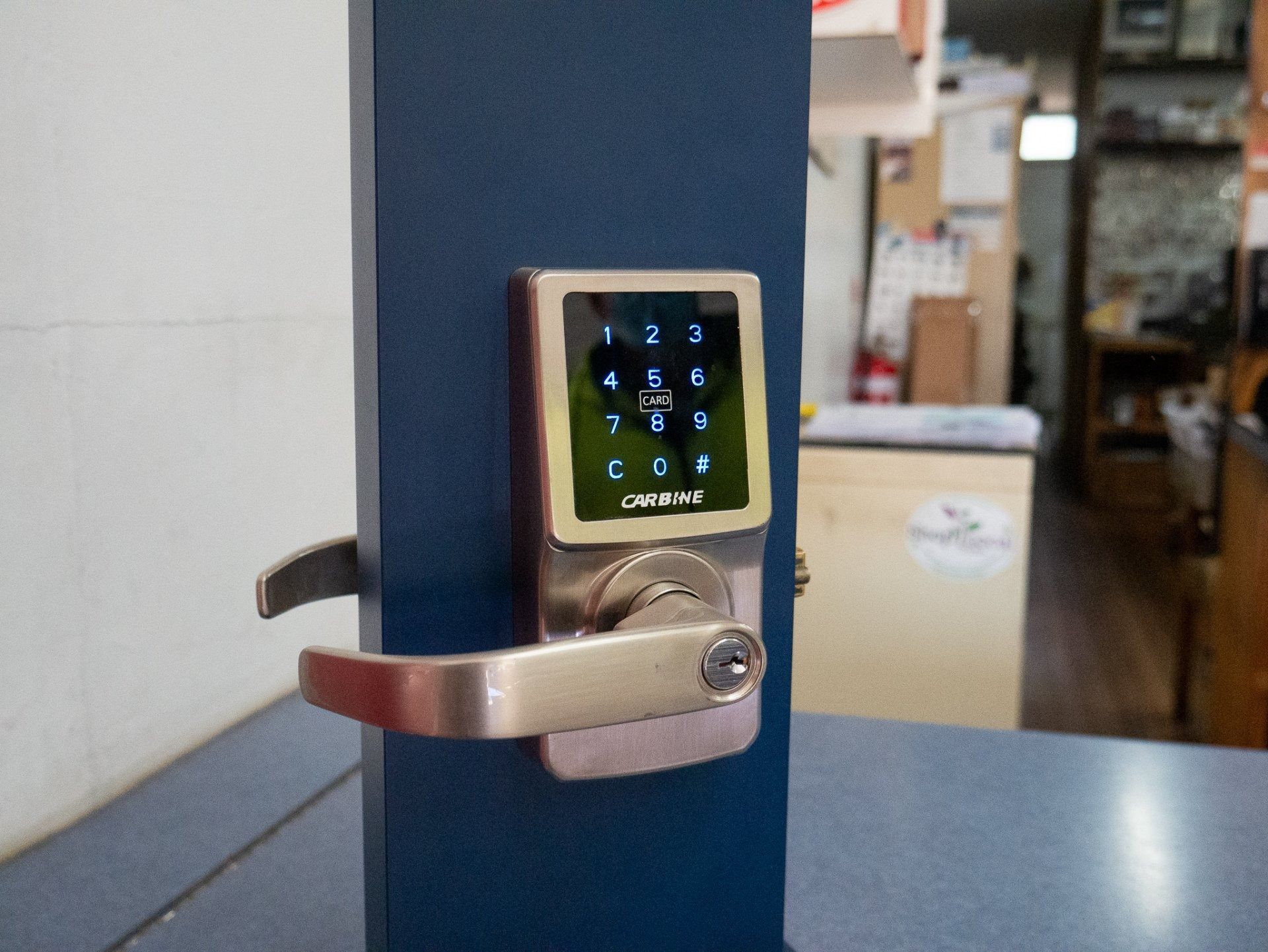 A Door Lock With A Keypad Is Sitting On A Counter — Grafton Locksmith Service In Grafton, NSW