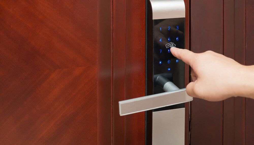 A Person Is Pressing A Button On A Digital Door Lock — Grafton Locksmith Service In Grafton, NSW