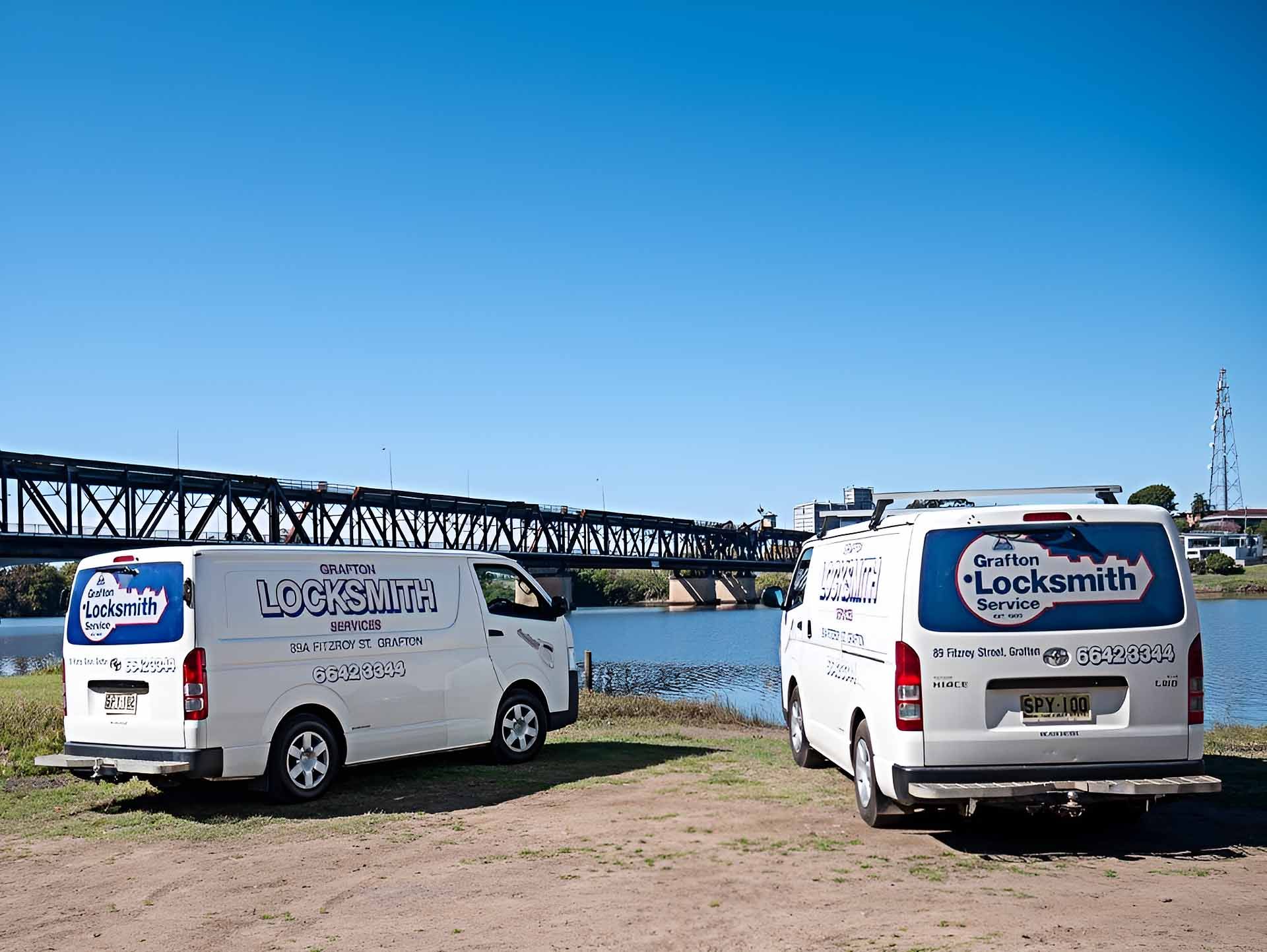 Two Vans Are Parked Next To Each Other In Front Of A Body Of Water — Grafton Locksmith Service In Grafton, NSW