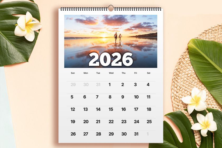 A calendar with flowers on a wooden table