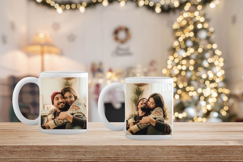 A white coffee mug with a picture of a man and a woman on it