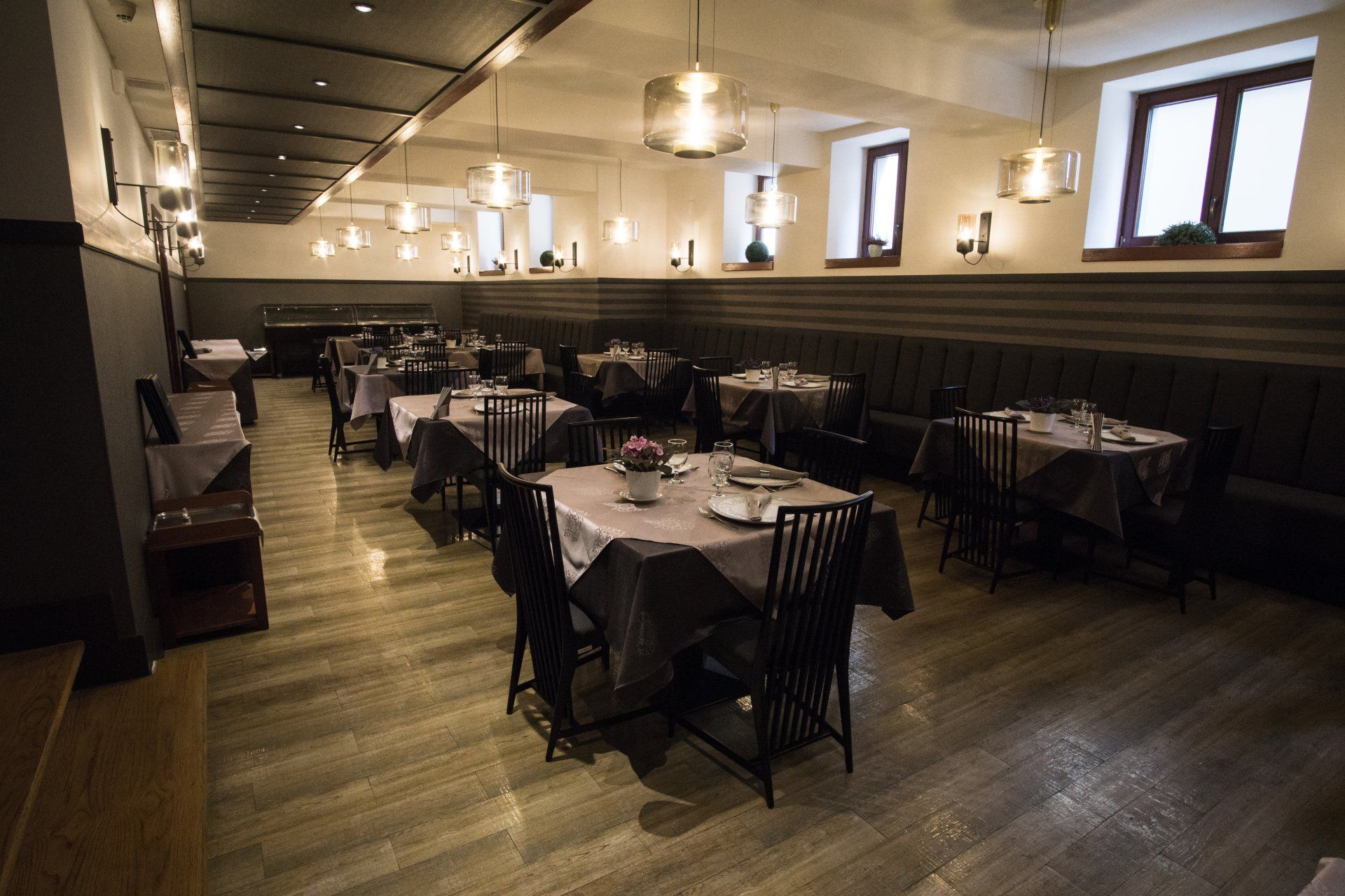 A large dining room with tables and chairs in a restaurant.