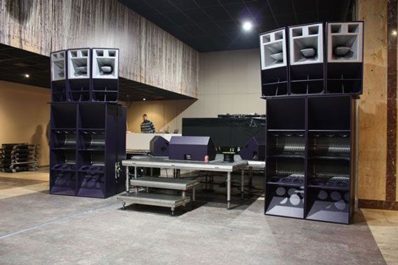 Two large Funktion-One sound towers in a backstage audio setup environment.