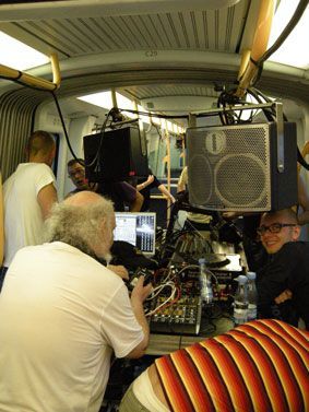 Live DJ setup with Funktion-One speaker inside a crowded train car.
