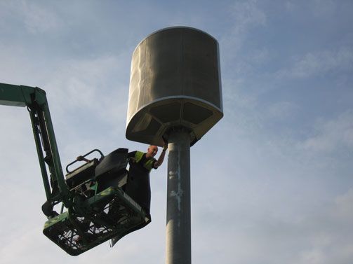 Technician Installing Large Outdoor Speaker System