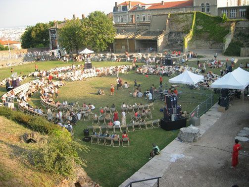 Open-air performance with circular audience setup and Funktion-One speakers.