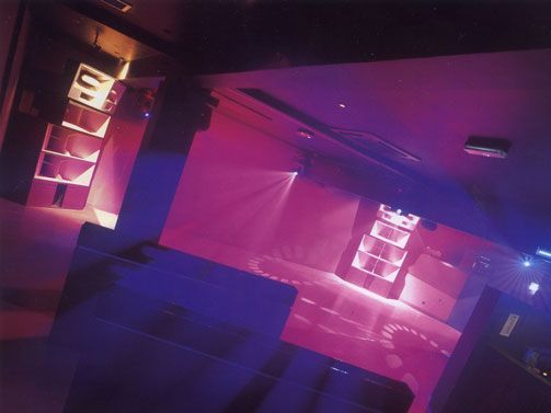 Nightclub interior with pink neon lighting and modern sound system