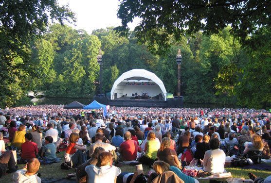 Open-Air Concert Stage in Park with Festival Crowd