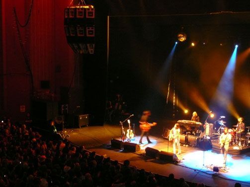 Concert stage with band and spotlight beams