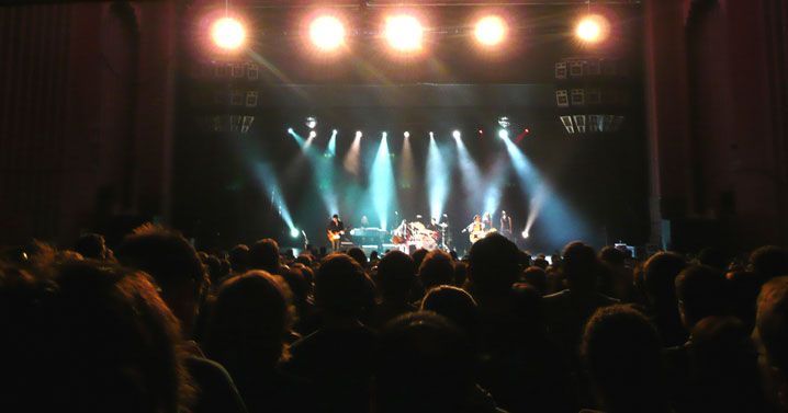 Crowd watching live band under bright stage lights