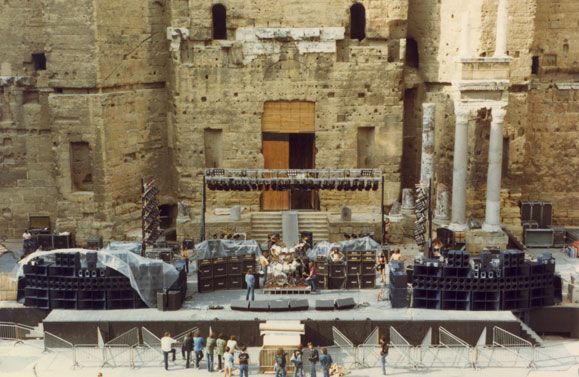 Large outdoor concert stage setup with sound system and lighting rig