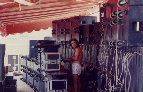 Vintage backstage sound system with a technician adjusting speakers