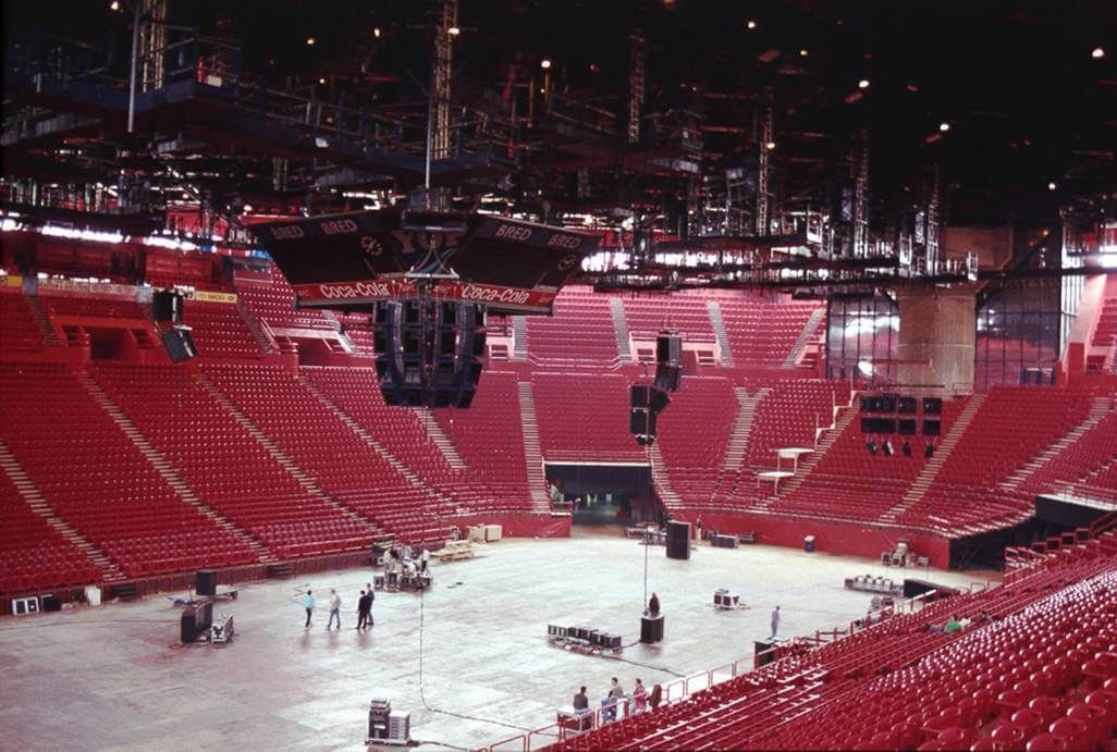 Empty sports arena with stage rigging and red seating