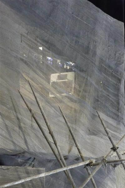 Funktion-One speaker partially visible behind gauze curtain with rigging poles.