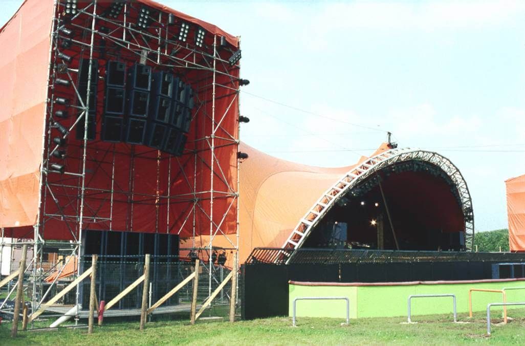 Festival stage with orange tent and towering line arrays