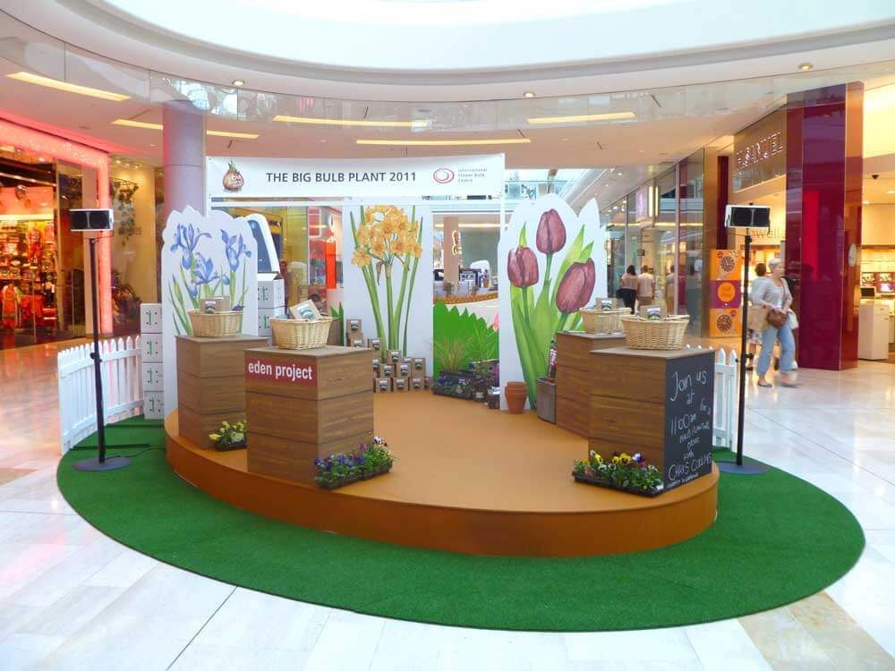 Shopping mall flower event display with a small stage