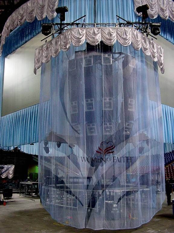 Arena center speaker cluster wrapped in themed fabric, draping