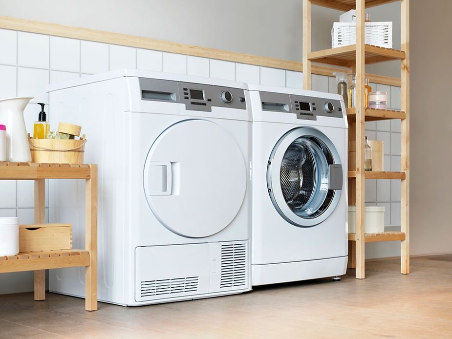 A washer and dryer are sitting next to each other in a laundry room.