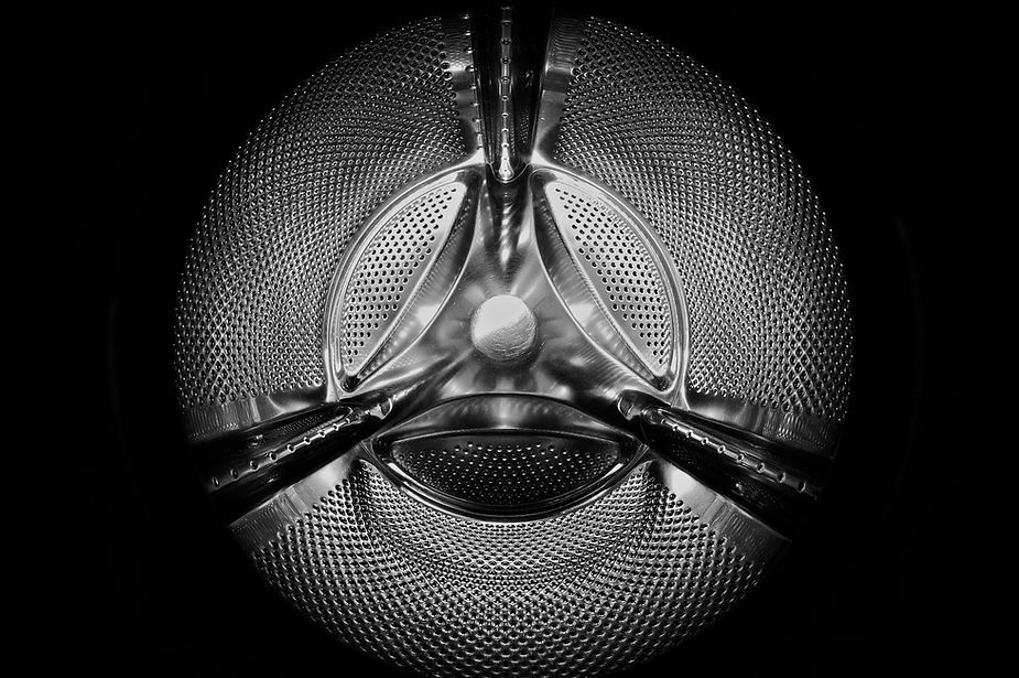A black and white photo of a washing machine drum.