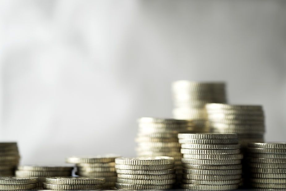 Stacks of coins are stacked on top of each other on a table.
