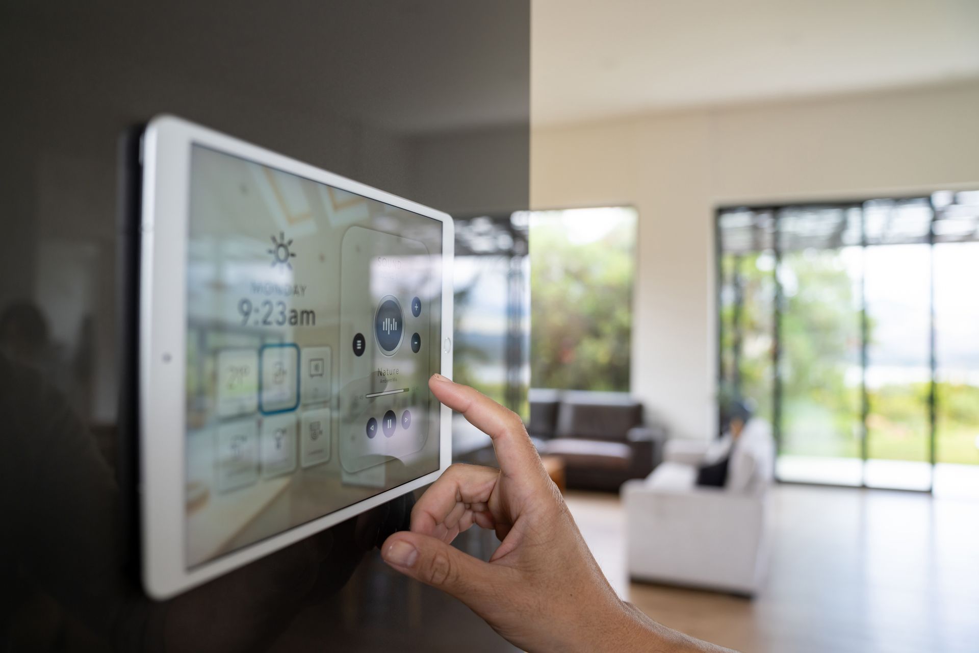 A person is using a tablet to control a smart home.