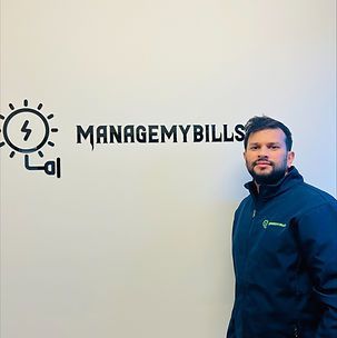 A man is standing in front of a wall that says managemybills