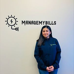 A woman is standing in front of a wall with the words `` managemy bills '' written on it.