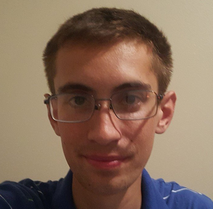 A young man wearing glasses and a blue shirt