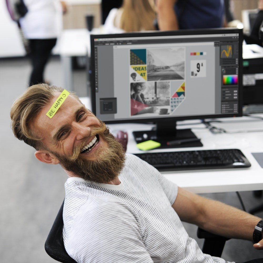 A man with a sticker on his forehead that says do n't laugh