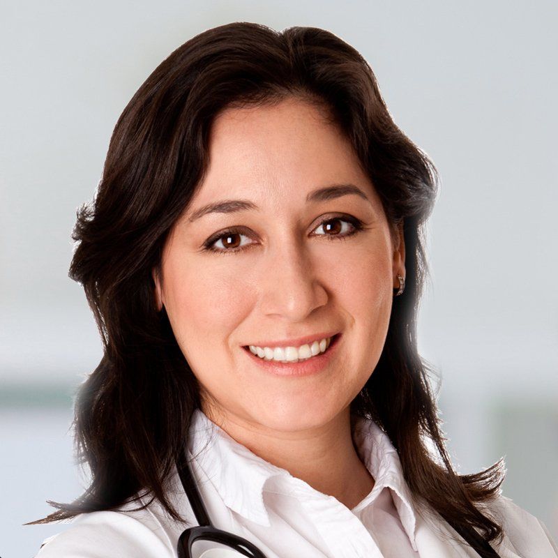 A smiling female doctor with a stethoscope around her neck