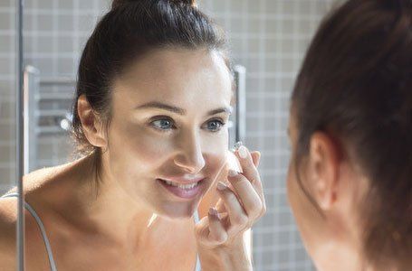 Girl applying lenses