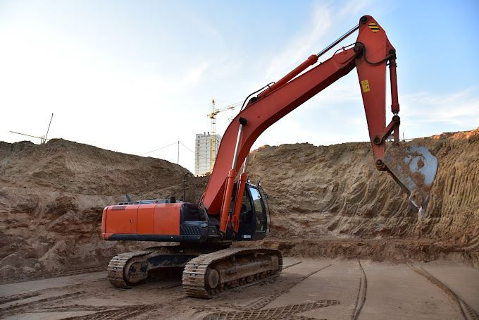 A bulldozer is working on a concrete sidewalk.