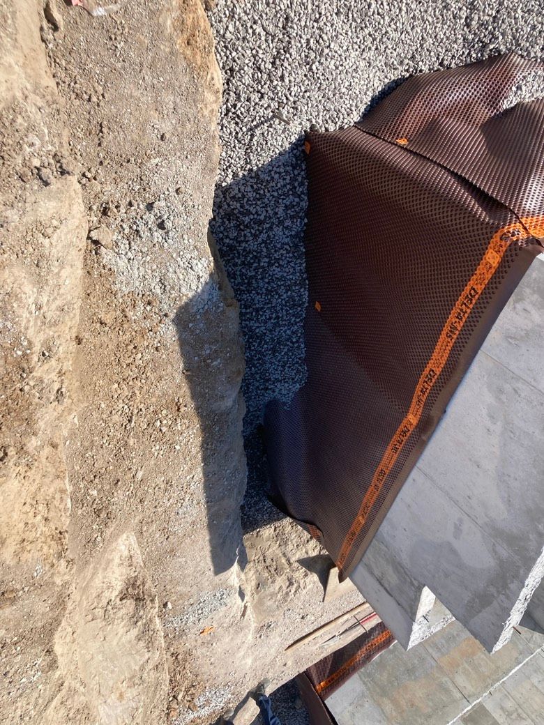 A piece of wood is sitting on top of a pile of dirt.