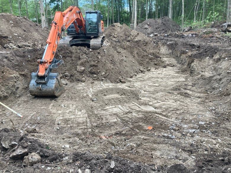A large excavator is digging a hole in the dirt.
