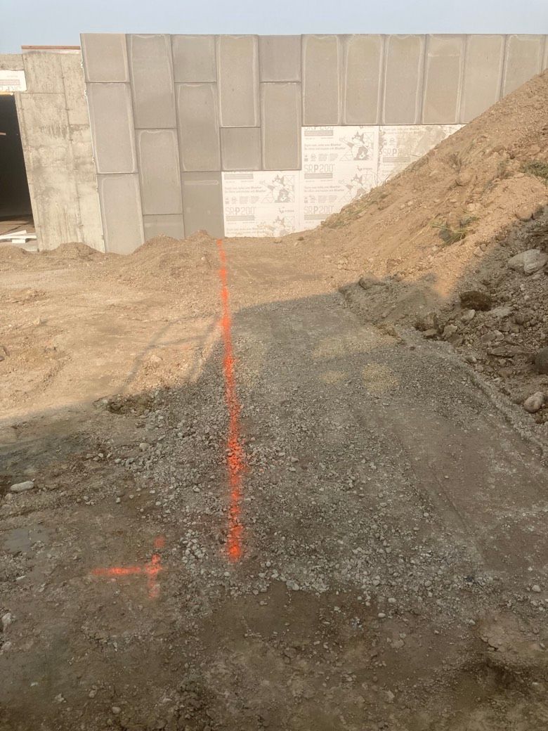 A construction site with a red line in the dirt.
