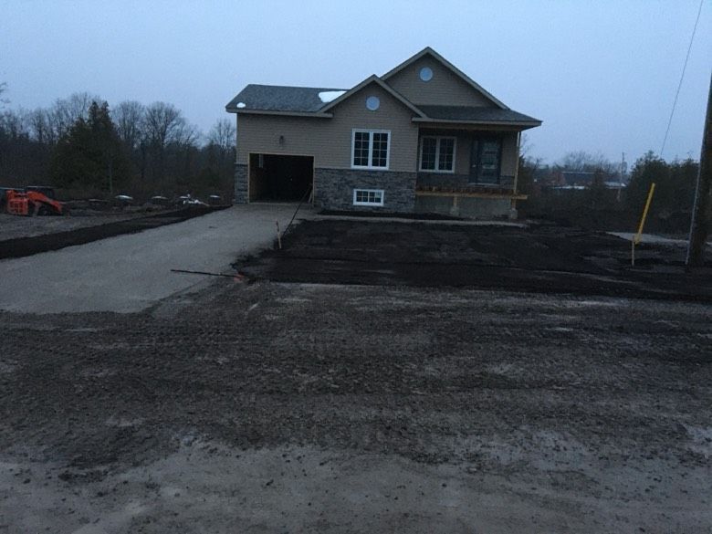 A house in the middle of a dirt road