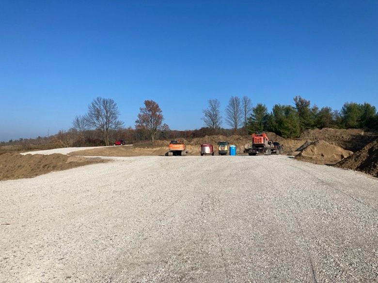 A gravel road with a lot of trucks on it