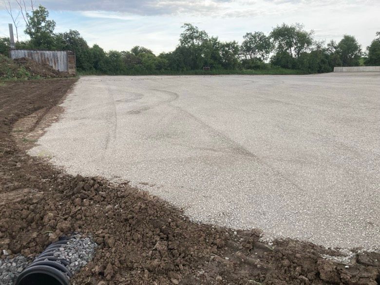A dirt road with a pipe in the middle of it.