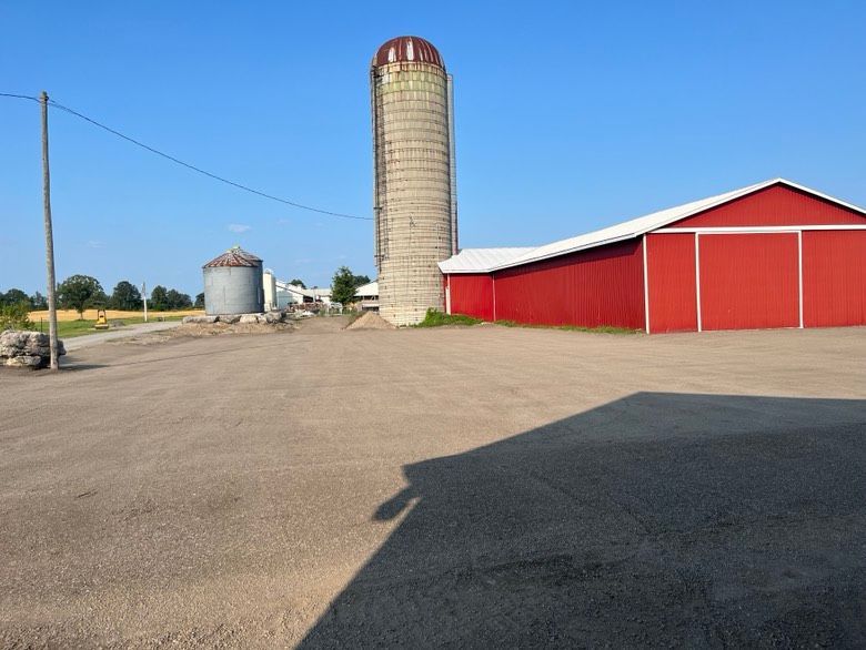 A red barn with a silo in the background