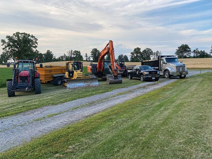 A yellow bulldozer is parked in a dirt field.