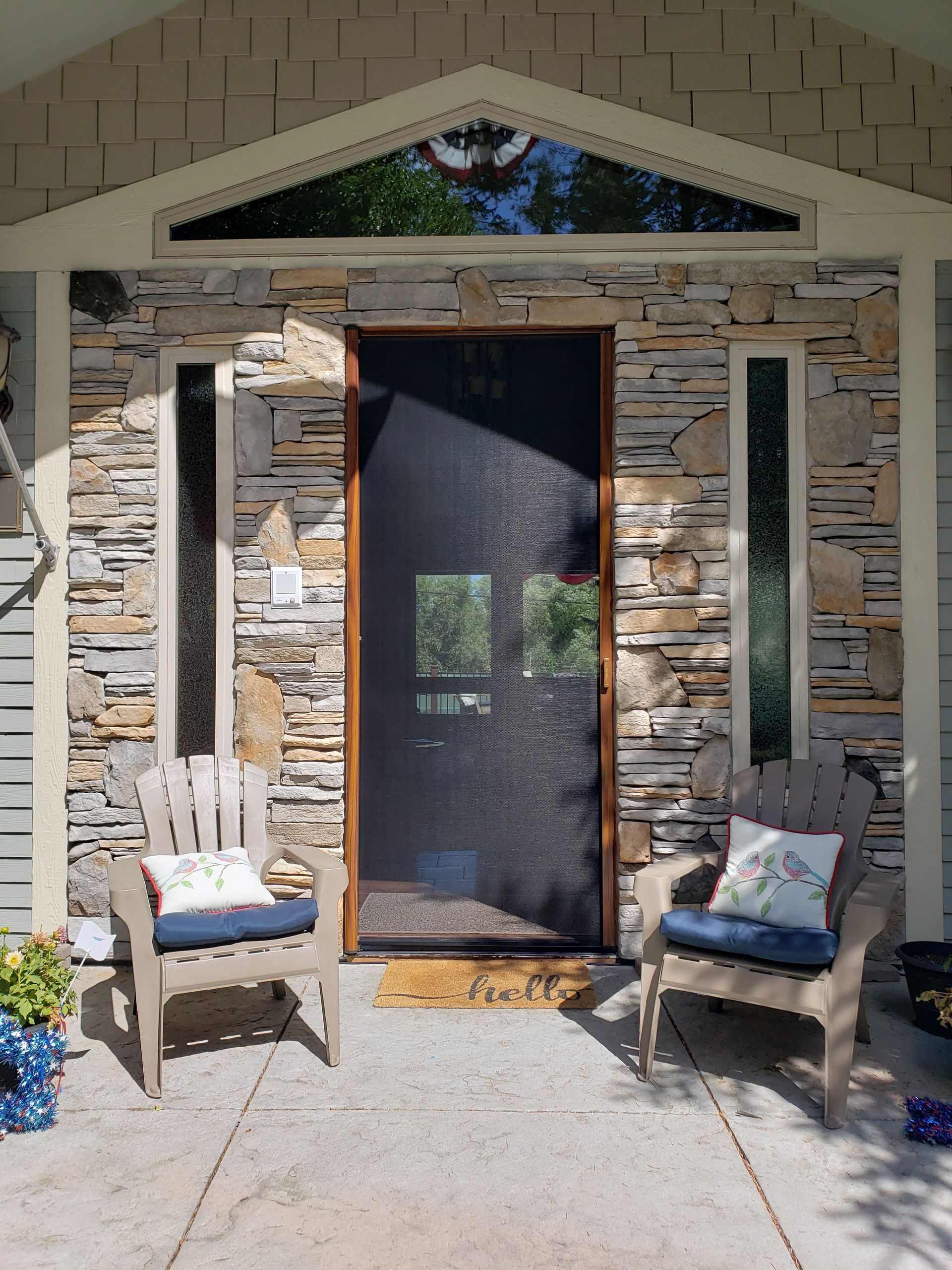A dining room with a table and chairs and shutters on the windows.