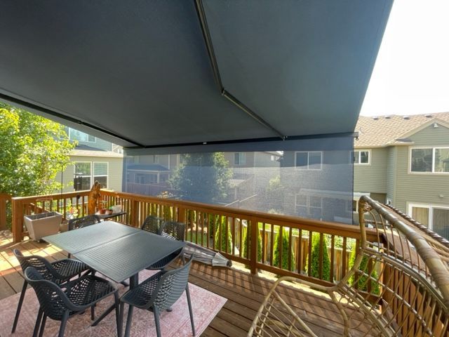 A living room with a couch wicker chairs and a coffee table